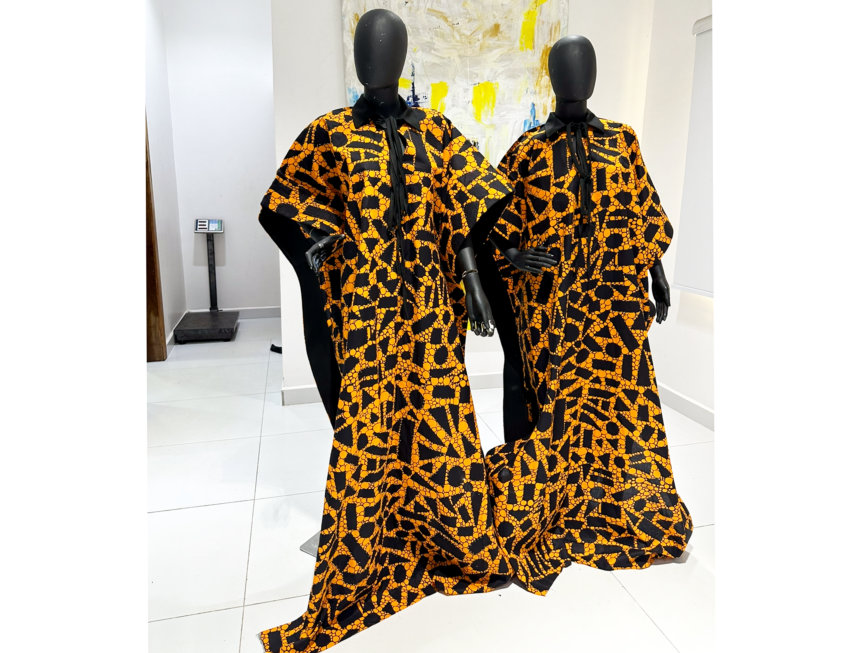 two personnequins wearing black and orange dress design