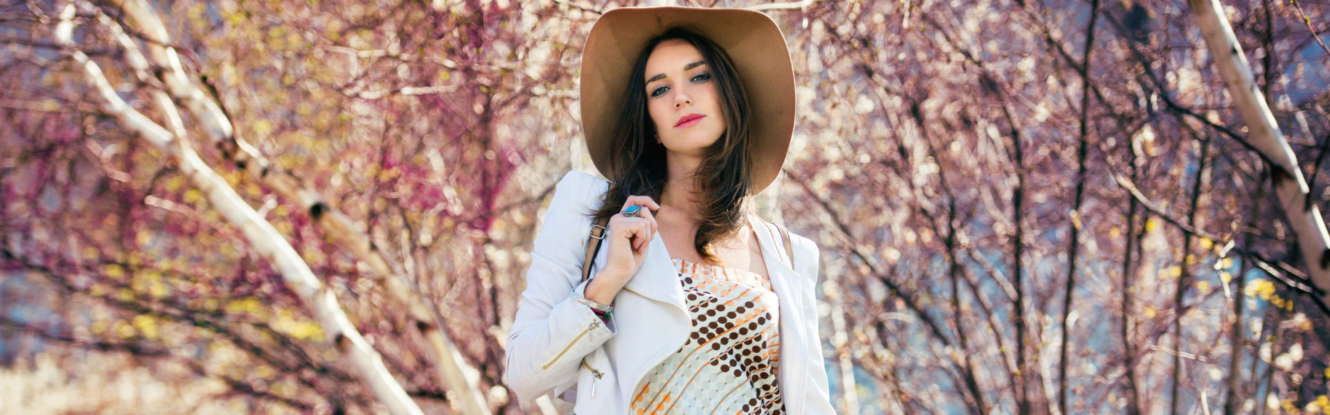 woman walking in spring park wearing fashionable outfit